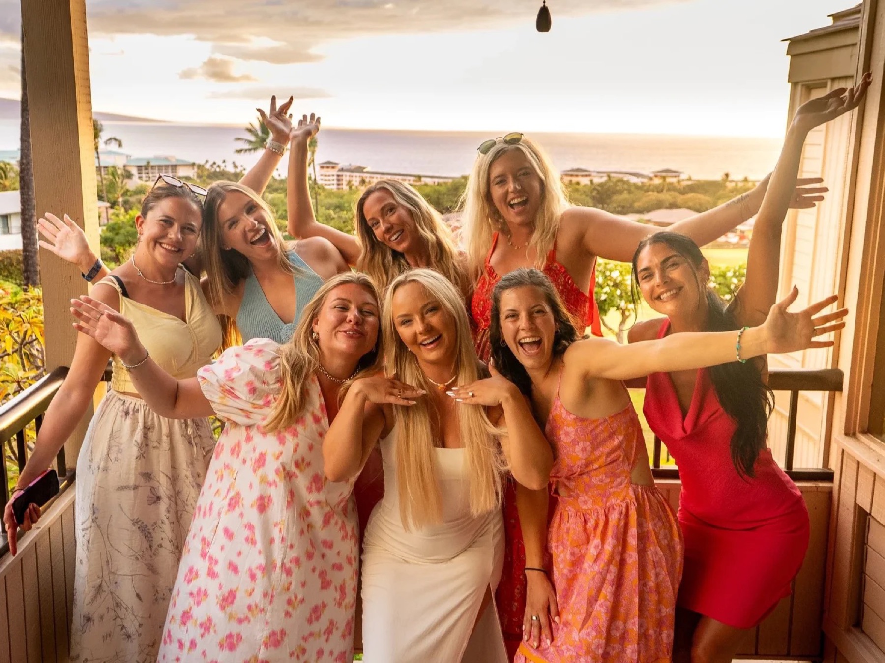 Bridal party celebrating on a terrace overlooking the coast
