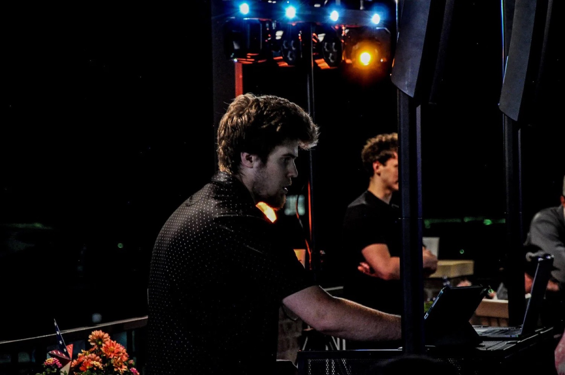 DJ performing under stage lighting